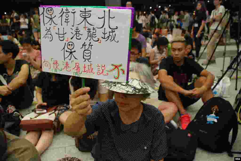 靜坐示威者高舉示威標語，反對新界東北發展是「深港同城」計劃 (美國之音湯惠芸拍攝）