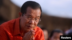 FILE - Cambodia's Prime Minister Hun Sen attends a ceremony at the Angkor Wat temple to pray for peace and stability in Cambodia, Dec. 3, 2017.