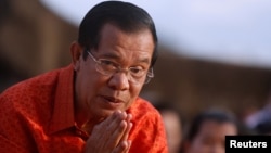 FILE - Cambodia's Prime Minister Hun Sen attends a ceremony at the Angkor Wat temple to pray for peace and stability in Cambodia, Dec. 3, 2017.