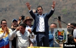 FILE - Venezuelan opposition leader Juan Guaido, who many nations have recognized as the country's rightful interim ruler, takes part in a rally against President Nicolas Maduro's government in Valencia, Venezuela, March 16, 2019.