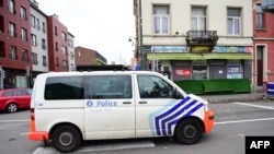 A police van makes its way to arrest people in connection with the deadly attacks in Paris, in Brussels' Molenbeek district, on Nov. 15, 2015. 