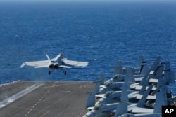 FILE - In this May 3, 2019, photo released by the U.S. Navy, an F/A-18E Super Hornet launches from the flight deck of the aircraft carrier USS Abraham Lincoln. The U.S. sent the Lincoln and other military resources to the Middle East following "clear indications" that Iran and its proxy forces were preparing to possibly attack U.S. forces in the region, a defense official said on May 5, 2019.