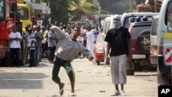 Muslim youth throw stones at riot police outside Masjid Musa Mosque in Mombasa, Kenya, Aug. 28, 2012. 