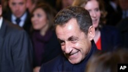 Former French President Nicolas Sarkozy leaves his headquarters in Paris, Nov. 29, 2014.