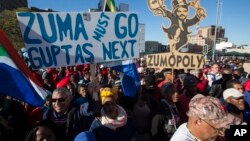 Protesters call for the removal of president Jacob Zuma in a march on Parliament in Cape Town, South Africa, Monday, Aug. 7, 2017. South Africa's parliament will vote by secret ballot on a motion of no confidence on South African President Jacob Zuma on 