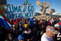 Protesters call for the removal of president Jacob Zuma in a march on Parliament in Cape Town, South Africa, Monday, Aug. 7, 2017. South Africa's parliament will vote by secret ballot on a motion of no confidence on South African President Jacob Zuma on Tuesday, the legislative body's speaker announced Monday.