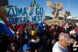 FILE - Protesters call for the removal of president Jacob Zuma in a march on Parliament in Cape Town, South Africa, Aug. 7, 2017.