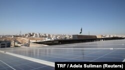 Solar panels look out across Amman city from the roof of the Al Hoffaz school in Amman, Jordan, Sept. 25, 2018. 