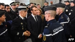 French President Emmanuel Macron, center, meets gendarmerie and police forces during his visit in the French northern city of Calais Jan. 16, 2018.