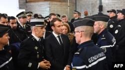 French President Emmanuel Macron (C) meets gendarmerie and police forces during his visit in the French northern city of Calais, Jan. 16, 2018.