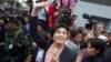 Ousted Thai Prime Minister Yingluck Shinawatra waves to her supporters in Bangkok, Thailand, May 7, 2014.