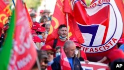 Demonstrators take part in a march organized by Italy's main labor unions, in Rome's St. John Lateran square, Oct. 16, 2021.