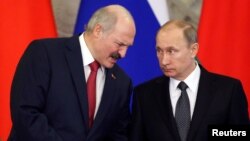 FILE - Russia's President Vladimir Putin listens to his Belarussian counterpart Alexander Lukashenko as they attend a signing ceremony during a session of the Supreme State Council of the Union State at the Kremlin in Moscow, March 3, 2015. 