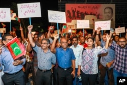Maldivian opposition supporters shout slogans during a protest as they the urge the government to obey a Supreme Court order to release and retry political prisoners, in Male, Maldives, Feb. 4, 2018.