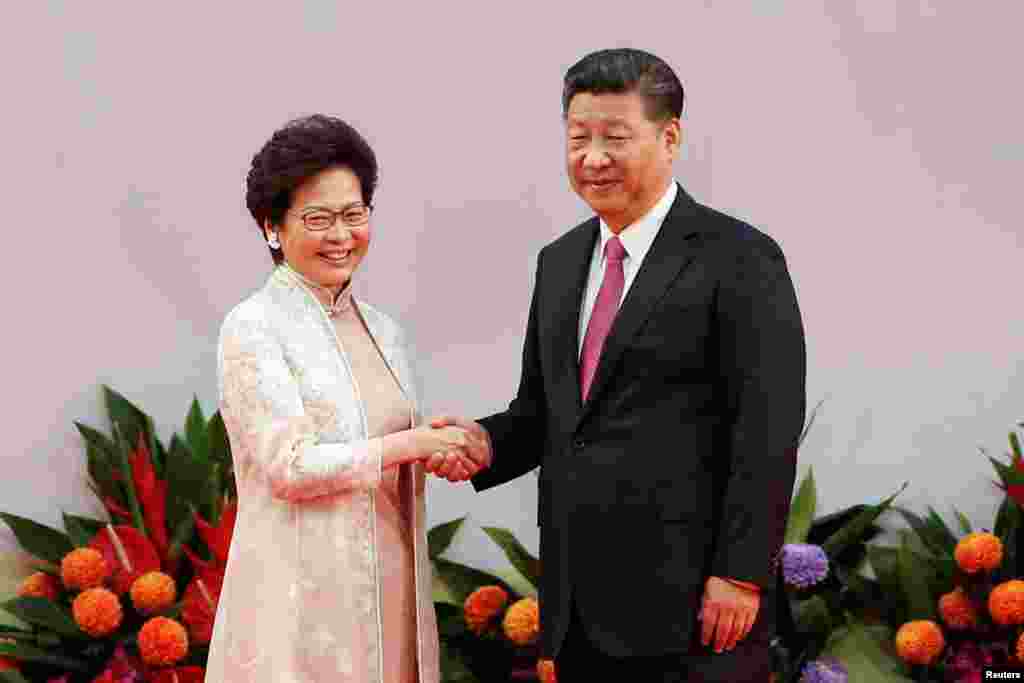 Hong Kong Chief Executive Carrie Lam shakes hands with Chinese President Xi Jinping after she swore an oath of office on the 20th anniversary of the city's handover from British to Chinese rule, in Hong Kong, China, July 1, 2017.