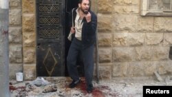 A man reacts as he stands on bloodstains at a site hit by airstrikes in the rebel-held area of Aleppo's al-Fardous district, Syria, April 29, 2016. 