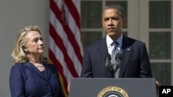 FILE - President Barack Obama, with then-Secretary of State Hillary Clinton, speaks in the Rose Garden of the White House, Sept. 12, 2012.