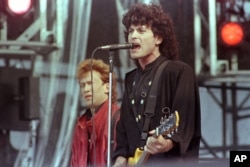 FILE - Eric Bazilian, lead singer of the The Hooters, performs during the Live Aid famine relief concert at JFK Stadium in Philadelphia, Pa., July 13,1985.
