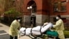 Dua petugas membawa seorang pria lansia yang diduga terpapar Covid-19 dari panti jompo Cobble Hill di Brooklyn, New York. 