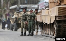 FILE - Turkish soldiers are seen in the center of Afrin, Syria, March 24, 2018.