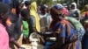  Cameroonians who fled deadly intercommunal violence between herders and farmers get food at a temporarily refugee camp on the outskirts of Ndjamena, Chad, Dec. 13, 2021. 