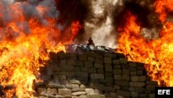 A pile of marijuana and other drugs are being incinerated in Tijuana, Mexico. (August 18, 2015.) 