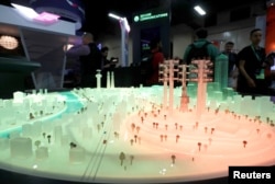 FILE - A portion of a city model glows red, indicating a cyberthreat to infrastructure, at the DarkMatter booth during the Black Hat information security conference in Las Vegas, July 26, 2017.