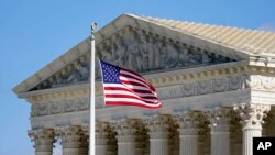 FILE - An American flag waves in front of the Supreme Court building on Capitol Hill in Washington, Nov. 2, 2020.