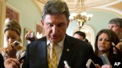 Democratic Senator Joe Manchin of West Virginia is followed by reporters after a meeting on gun control, on Capitol Hill in Washington, D.C., April 9, 2013.