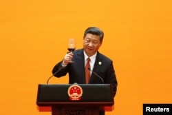 FILE - Chinese President Xi Jinping makes a toast at the welcoming banquet at the Great Hall of the People during the first day of the Belt and Road Forum in Beijing, China, May 14, 2017.