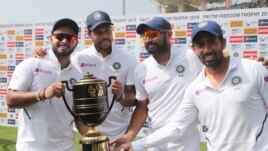 From left, India's Rishabh Pant, Umesh Yadav, Mohammed Shami and Wriddhiman Saha pose with the winners trophy after their win on the fourth day of third and last cricket test match between India and South Africa in Ranchi, India, Tuesday, Oct. 22, 2019. I