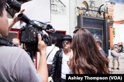 A Korean film crew interviews Eduardo Lezcano (Argentina), who is dresses up as Michael Jackson.