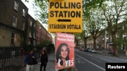 A Pro-Choice poster featuring Savita Halappanavar is placed near a sign for a polling station ahead of a May 25 referendum on abortion law, in Dublin, Ireland, May 23, 2018. 