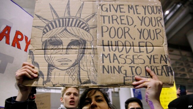 Demonstrators converge outside Terminal 5 of O'Hare International Airport, Jan. 29, 2017, in Chicago, as people protest President Donald Trump's executive order banning travel to the United States by citizens of several countries.