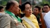 Burma's opposition leader Aung San Suu Kyi speaks with Deputy Minister for Border Affairs Major General Zaw Win during the 68th Armed Forces Day in Naypyitaw, March 27, 2013. 