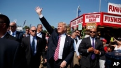 Republican presidential candidate Donald Trump waves during a visit to the 170th Canfield Fair, Sept. 5, 2016, in Canfield, Ohio.