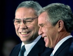 FILE - In this Dec. 16. 2000 file photo, President-elect Bush smiles as he introduces retired Gen. Colin Powell as his nominee to be secretary of state during a ceremony in Crawford, Texas.