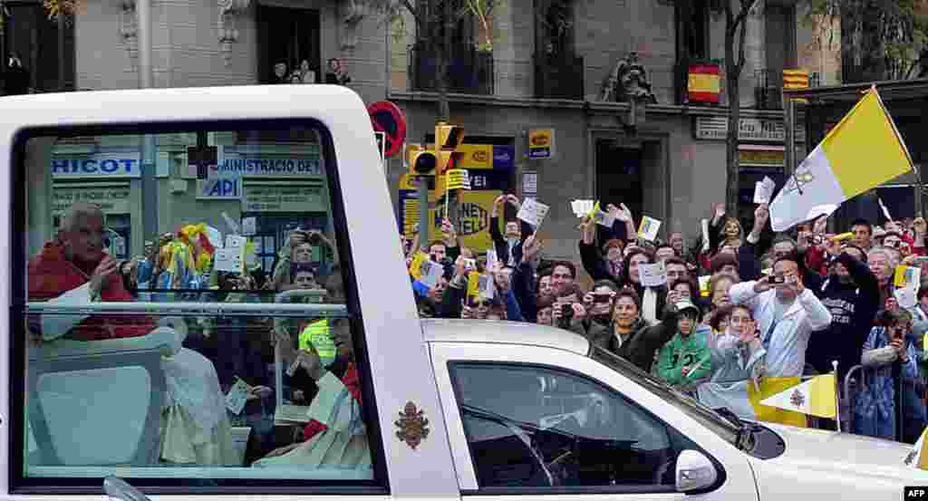 Pope Benedict XVI waves to the crowd during his visit in Barcelona, Spain, Sunday, Nov. 7, 2010. The Pope visited the city of Barcelona to consecrate La Sagrada Familia church. (AP Photo/Manu Fernandez)