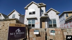 A "Sold" sign is seen posted in front of a house in the final stages of construction in Plano, Texas, Feb. 2, 2016.