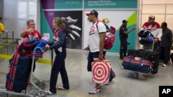 Members of the Russian Olympic delegation wheel past with their luggage after arriving at the Rio de Janeiro International Airport to compete at the 2016 Summer Olympics in Rio de Janeiro, Brazil, July 29, 2016.
