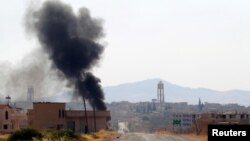 Smoke rises from Taybat al Imam town after rebel fighters from the hardline jihadist Jund al-Aqsa advanced in the town in Hama province, Syria August 31, 2016.