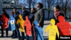 FILE - Activists take part in a flashmob to highlight human rights violations against Tatars living in Russia-annexed, in Kyiv, Ukraine, March 16, 2016.