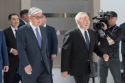 FILE - Kassym-Jomart Tokayev, left, then-interim president of Kazakhstan, and former President Nursultan Nazarbayev attend the Astana Economic Forum in Nur-Sultan, Kazakhstan, May 16, 2019.