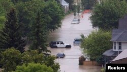  Vehicles surrounded by floodwaters are seen in the neighborhood of Sunnyside in Calgary, Alberta, Canada, June 21, 2013.