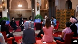 First lady Michelle Obama, rear center, actress and girls’ education advocate Meryl Streep, second right, and Indian actress Freida Pinto, left on sofa, participate in a conversation with adolescent girls in Marrakech, Morocco, June 28, 2016.