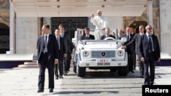 Pope Francis waves as he leaves after leading the weekly audience in Saint Peter's Square at the Vatican, Oct. 2, 2013.