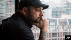 Christian Picciolini, founder of the group Life After Hate, poses for a photograph in his Chicago home, Jan. 9, 2017. Picciolini, a former skinhead, is an activist combatting what many see as a surge in white nationalism across the United States. He's doing it by helping members quit groups including the Ku Klux Klan and skinhead organizations.