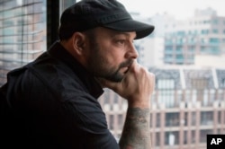 Christian Picciolini, founder of the group Life After Hate, poses for a photograph in his Chicago home, Jan. 9, 2017. Picciolini, a former skinhead, is an activist combatting what many see as a surge in white nationalism across the United States. He's doing it by helping members quit groups including the Ku Klux Klan and skinhead organizations.