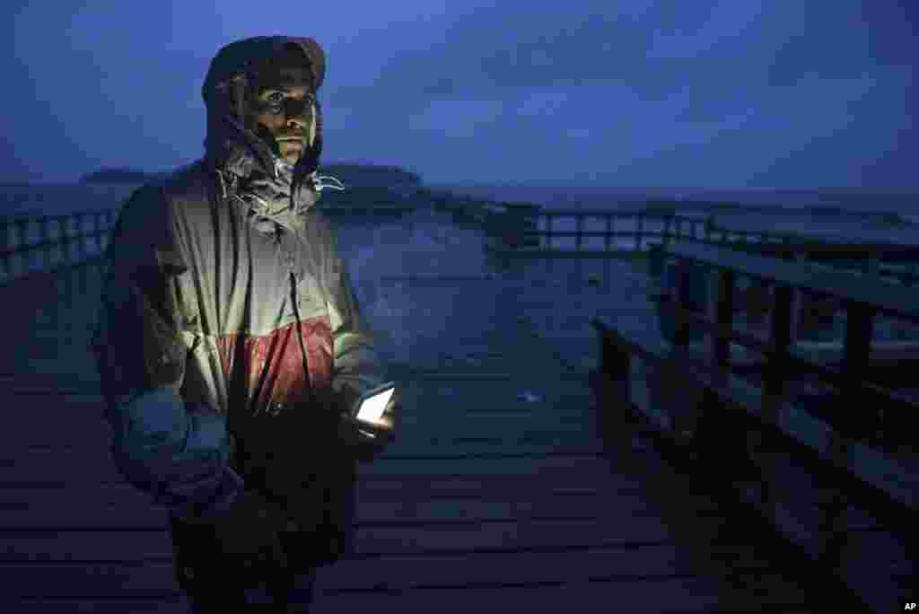 David Cruz Marrero watches the waves at Punta Santiago pier hours before the imminent impact of Maria, a Category 5 hurricane that threatens to hit the eastern region of the island with sustained winds of 165 miles per hour, in Humacao, Puerto Rico, Sept.