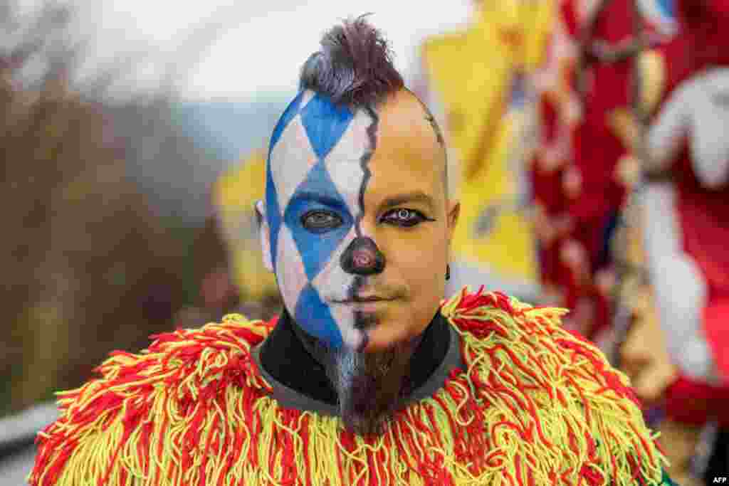 A man with a Chinese and Bavarian painting on the face participates in the traditional Chinese carnival parade in Dietfurt, Southern Germany.